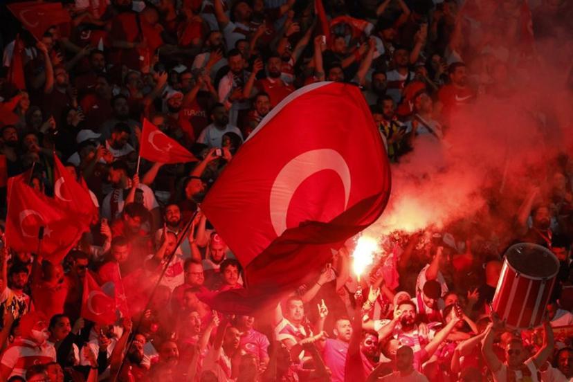 Turkey fans light flares and some make the controversial hand gesture associated with Turkish right-wing extremist group Grey Wolves during the UEFA Euro 2024 quarter-final football match between the Netherlands and Turkey at the Olympiastadion in Berlin on July 6, 2024.  Odd ANDERSEN / AFP