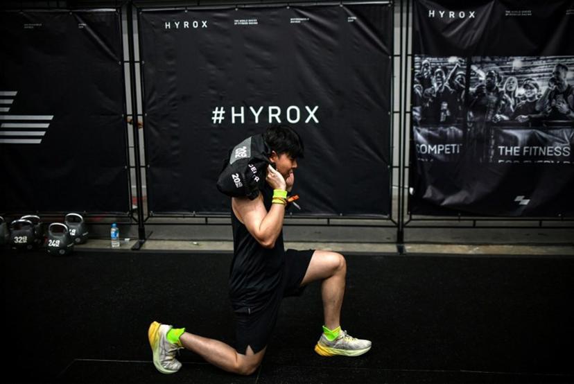 A participant warms up before competing in the Hyrox fitness race at the Bangkok International Trade and Exhibition Centre (BITEC) in Bangkok on March 21, 2026.  Amaury PAUL / AFP