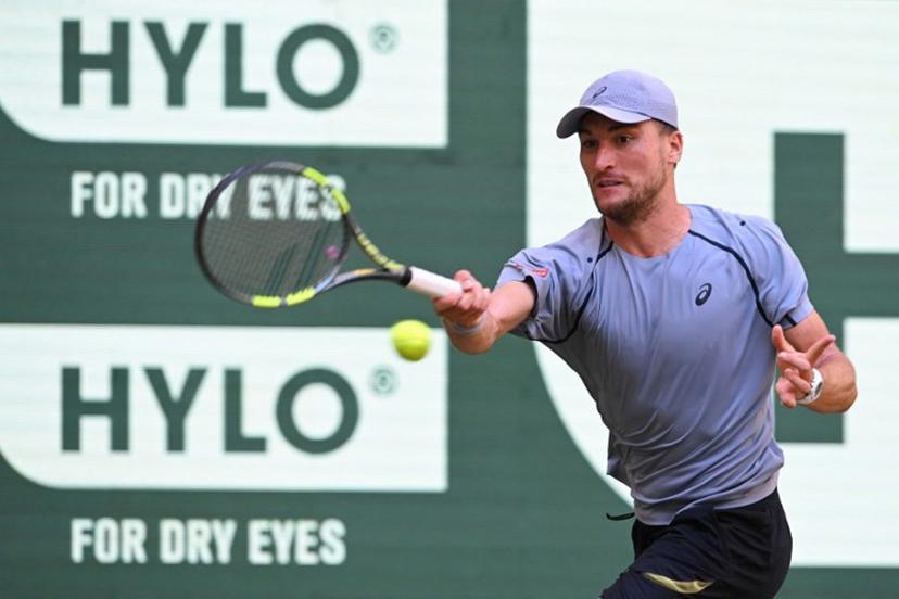 Belgium's Raphael Collignon returns the ball to Germany's Alexander Zverev during their men's singles quarter-final match of the Halle Open ATP tennis tournament in Halle, western Germany, on June 19, 2026.  CARMEN JASPERSEN / AFP