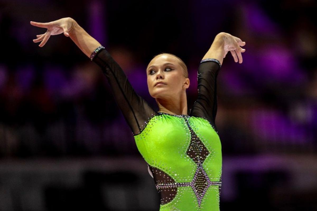 First-placed Individual Neutral Athlete (AIN) Angelina Melnikova competes on the floor exercise for the women's all-around final at the 53rd FIG Artistic Gymnastics World Championships in Jakarta on October 23, 2025.  Yasuyoshi CHIBA / AFP