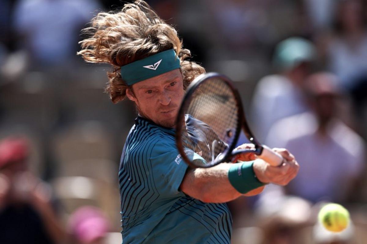 Andrey Rublev plays a forehand return to Argentina's Camilo Ugo Carabelli during their men's singles match on day 4 of the French Open tennis tournament on Court Simonne-Mathieu at the Roland-Garros Complex in Paris on May 27, 2026.  Anne-Christine POUJOULAT / AFP