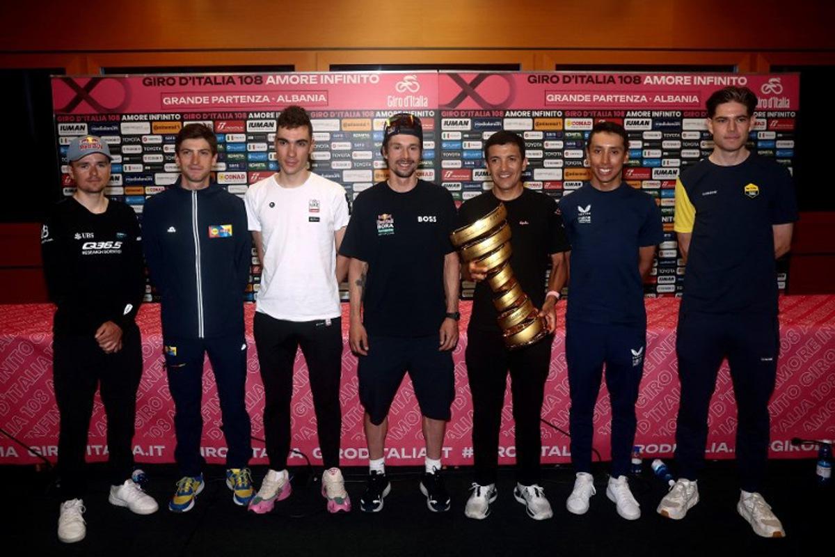 (FROM L) Q36.5 Pro Cycling Team's British rider Tom Pidcock, Lidl - Trek team's Italian rider Giulio Ciccone, UAE Team Emirates XRG's Spanish rider Juan Ayuso, Red Bull-Bora-Hansgrohe's Slovenian rider Primoz Roglic, EF Education - EasyPost's Ecuadorian rider Richard Carapaz, Ineos Grenadiers' Colombian rider Egan Bernal and Team Visma-Lease a Bike's Belgian rider Wout Van Aert pose with the Trofeo Senza Fine during the Top Riders press conference on the eve of the departure of the Giro d'Italia 2025 cycling race, in Tirana, on May 8, 2025. Luca BETTINI / AFP