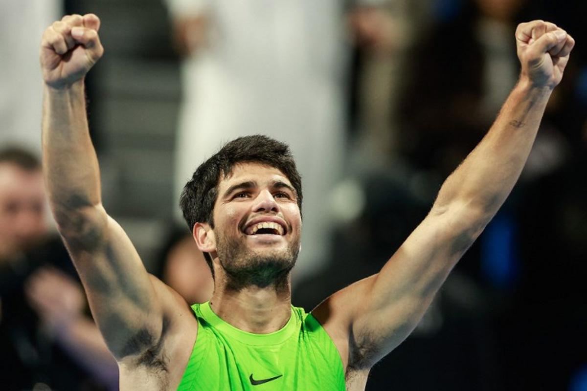 Spain's Carlos Alcaraz celebrates after winning his men's singles final match against France's Arthur Fils at the Qatar Open tennis tournament in Doha on February 21, 2026. Karim JAAFAR / AFP