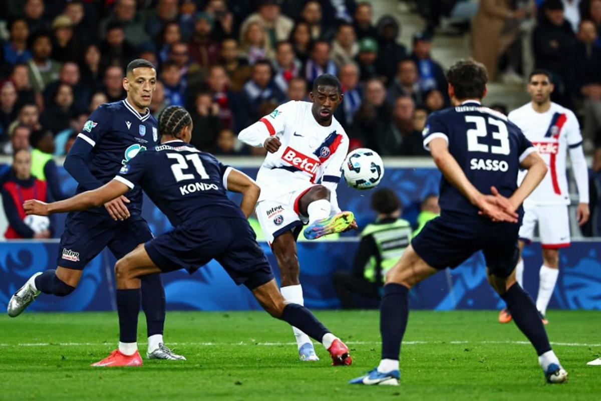 Paris Saint-Germain's French forward #10 Ousmane Dembele (C) kicks the ball during the French Cup (Coupe de France) semi-final football match between USL Dunkirk and Paris Saint-Germain (PSG) at the Pierre-Mauroy stadium in Villeneuve-d'Ascq, northern France, on April 1, 2025. Sameer Al-Doumy / AFP