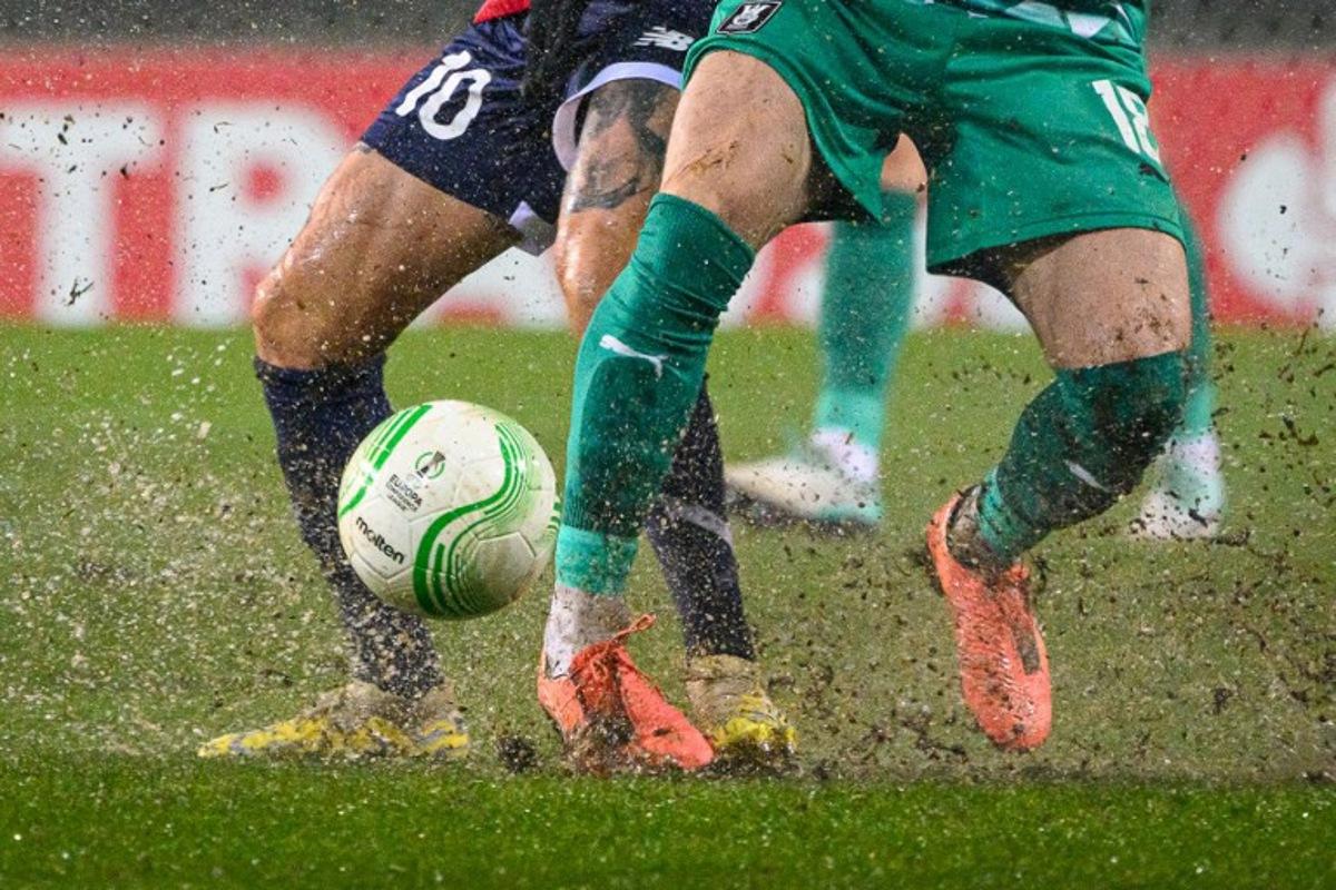Lille's French midfielder #10 Remy Cabella (L) fights for the ball with Olimpija's Slovenian forward #18 Marko Brest during the UEFA Europa Conference League Group A football match between NK Olimpija Ljubljana and LOSC Lille at the Stadium Stozice in Ljubljana on November 30, 2023. Jure Makovec / AFP