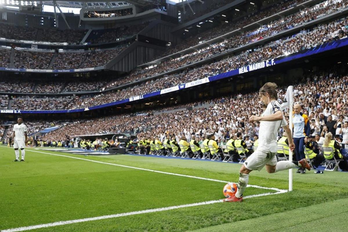 Real Madrid's Croatian midfielder #10 Luka Modric takes a corner during the Spanish league football match between Real Madrid CF and Real Sociedad at Santiago Bernabeu Stadium in Madrid on May 24, 2025. OSCAR DEL POZO / AFP