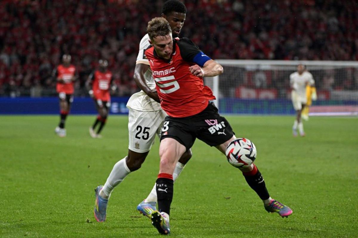 Rennes' French defender #03 Adrien Truffert (R) fights for the ball with Nice's French forward #25 Mohamed-Ali Cho during the French L1 football match between Stade Rennais FC and OGC Nice at Roazhon Park stadium in Rennes, western France on May 10, 2025. DAMIEN MEYER / AFP
