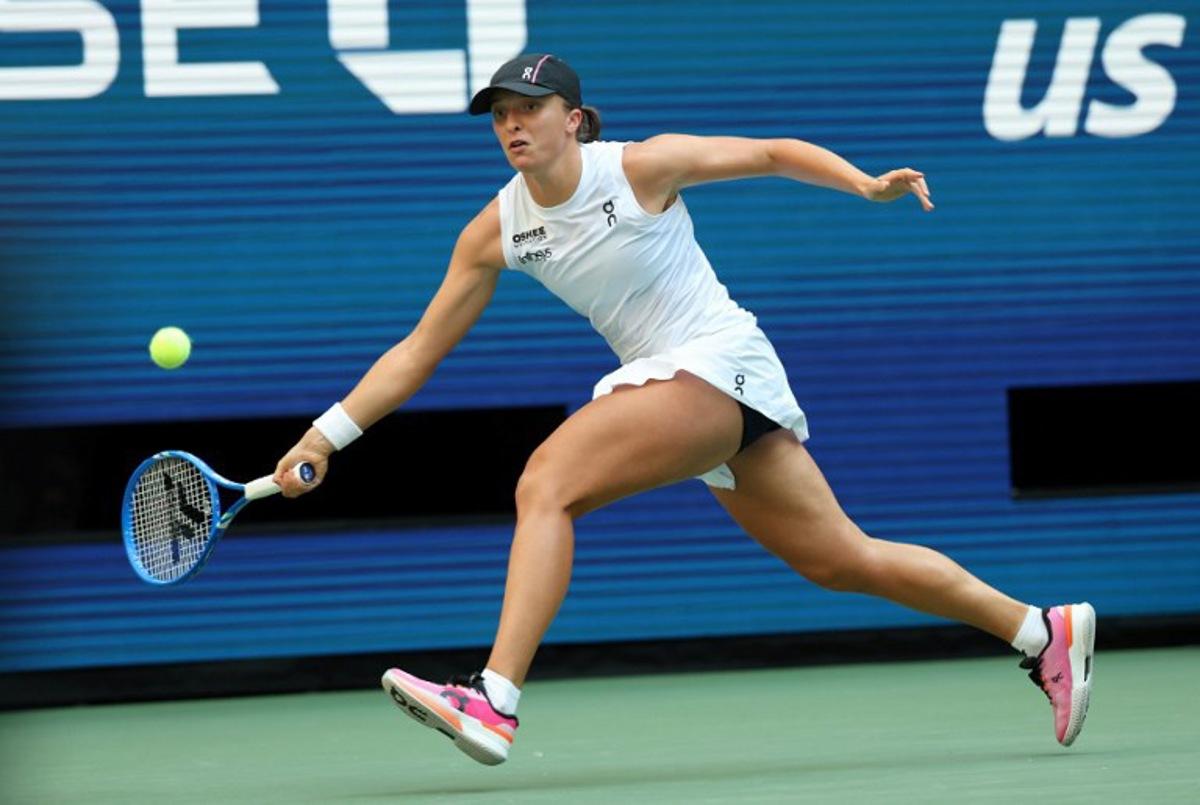 Poland's Iga Swiatek plays a shot to USA's Amanda Anisimova during their women's singles quarterfinal tennis match on day eleven of the US Open tennis tournament at the USTA Billie Jean King National Tennis Center in New York City on September 3, 2025. TIMOTHY A. CLARY / AFP