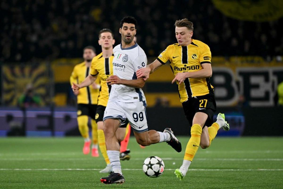 Inter Milan's Iranian forward #99 Mehdi Taremi (L) vies with Young Boys' Swiss defender #27 Lewin Blum (R) during the UEFA Champions League, league phase day 3, football match between Young Boys and Inter Milan at the Wankdorf Stadium in Bern on October 23, 2024. Fabrice COFFRINI / AFP