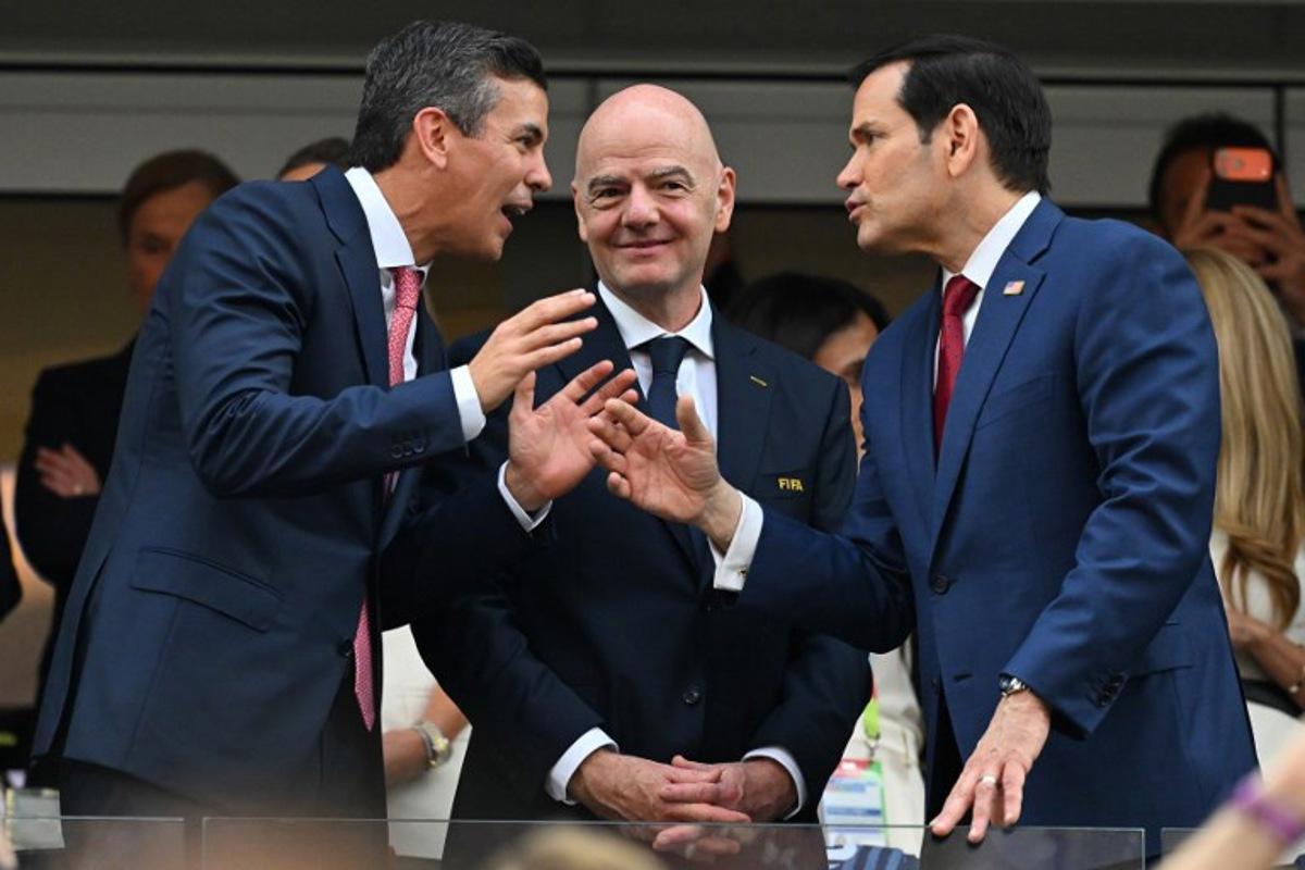 (L-R) Paraguayan President Santiago Pena, FIFA president Gianni Infantino, and US Secretary of State Marco Rubio talk ahead of the 2026 World Cup Group D football match between USA and Paraguay at the Los Angeles Stadium in Inglewood on June 12, 2026. Patrick T. Fallon / AFP