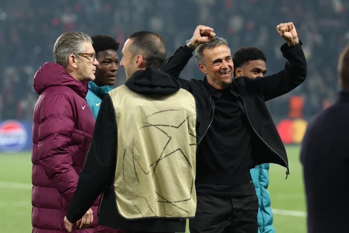 Paris Saint-Germain's Spanish coach Luis Enrique (R) celebrates his team's victory at the end of the UEFA Champions League semi-final second leg football match between Paris Saint-Germain (PSG) and Arsenal at the Parc des Princes stadium in Paris, on May 7, 2025. FRANCK FIFE / AFP
