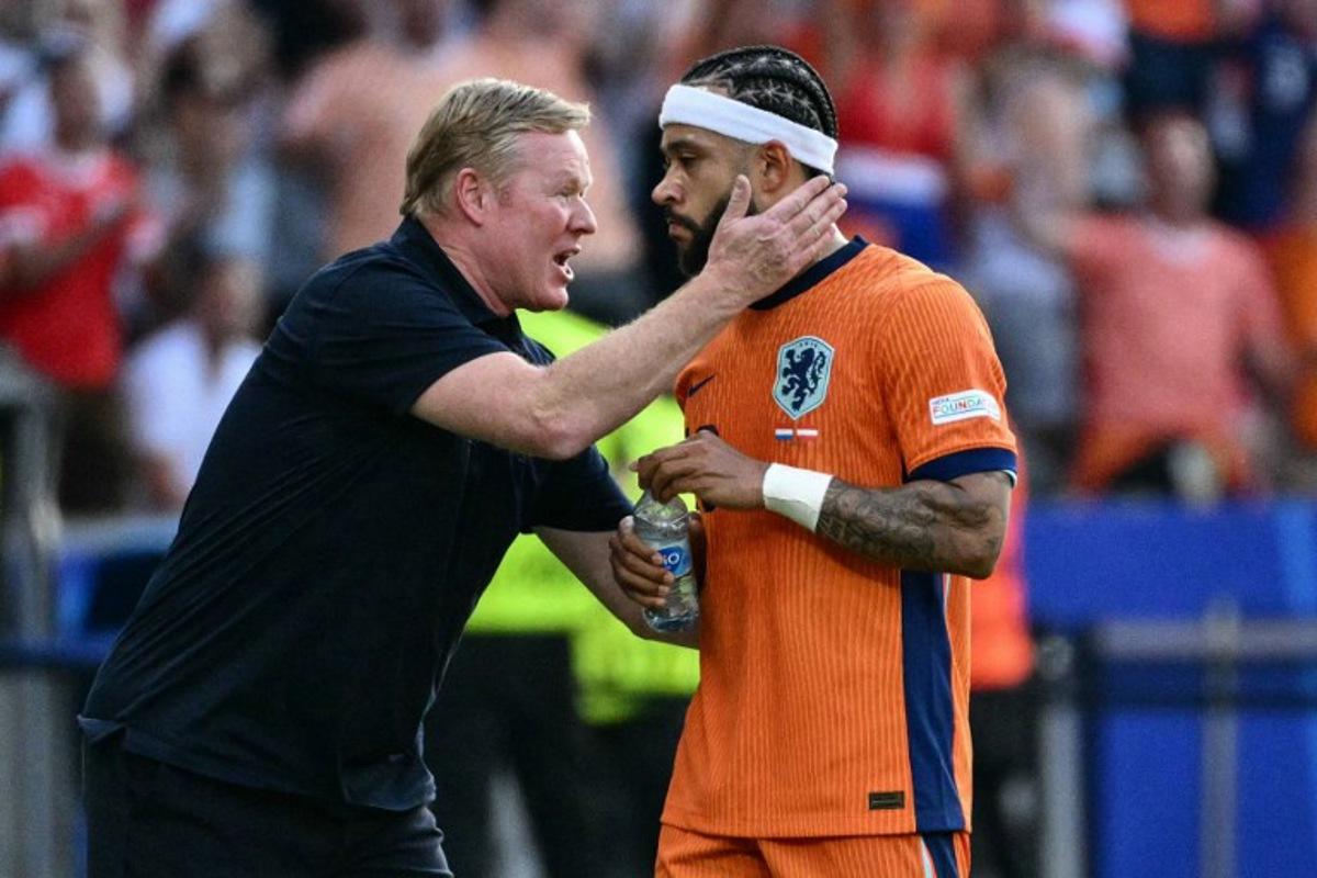 Netherlands' forward #10 Memphis Depay is congratulated by his head coach Ronald Koeman after scoring his team's second goal during the UEFA Euro 2024 Group D football match between the Netherlands and Austria at the Olympiastadion in Berlin on June 25, 2024. Christophe SIMON / AFP