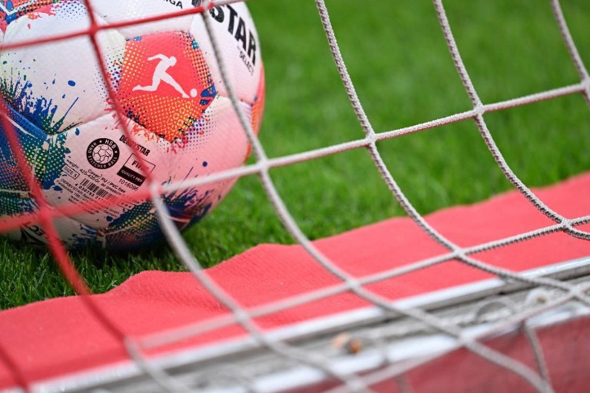 An official Derbystar matchball for the Bundesliga is pictured in the net prior to the German first division Bundesliga football match between 1 FSV Mainz 05 and Borussia Dortmund in Mainz, western Germany on September 27, 2025. Kirill KUDRYAVTSEV / AFP