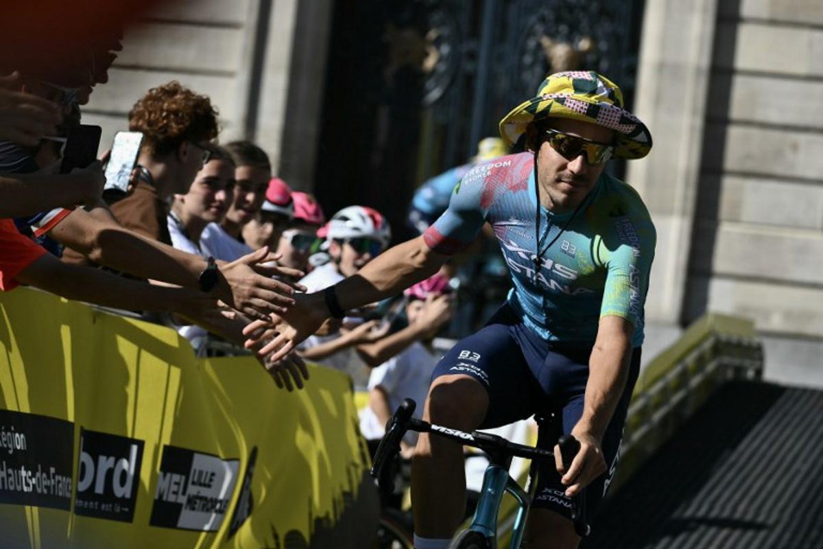 XDS Astana Team's Italian rider Davide Ballerini cycle through Lille's city center during the official teams presentation days prior to the start of the 112th edition of the Tour de France cycling race, in Lille, northern France, on July 3, 2025. Marco BERTORELLO / AFP