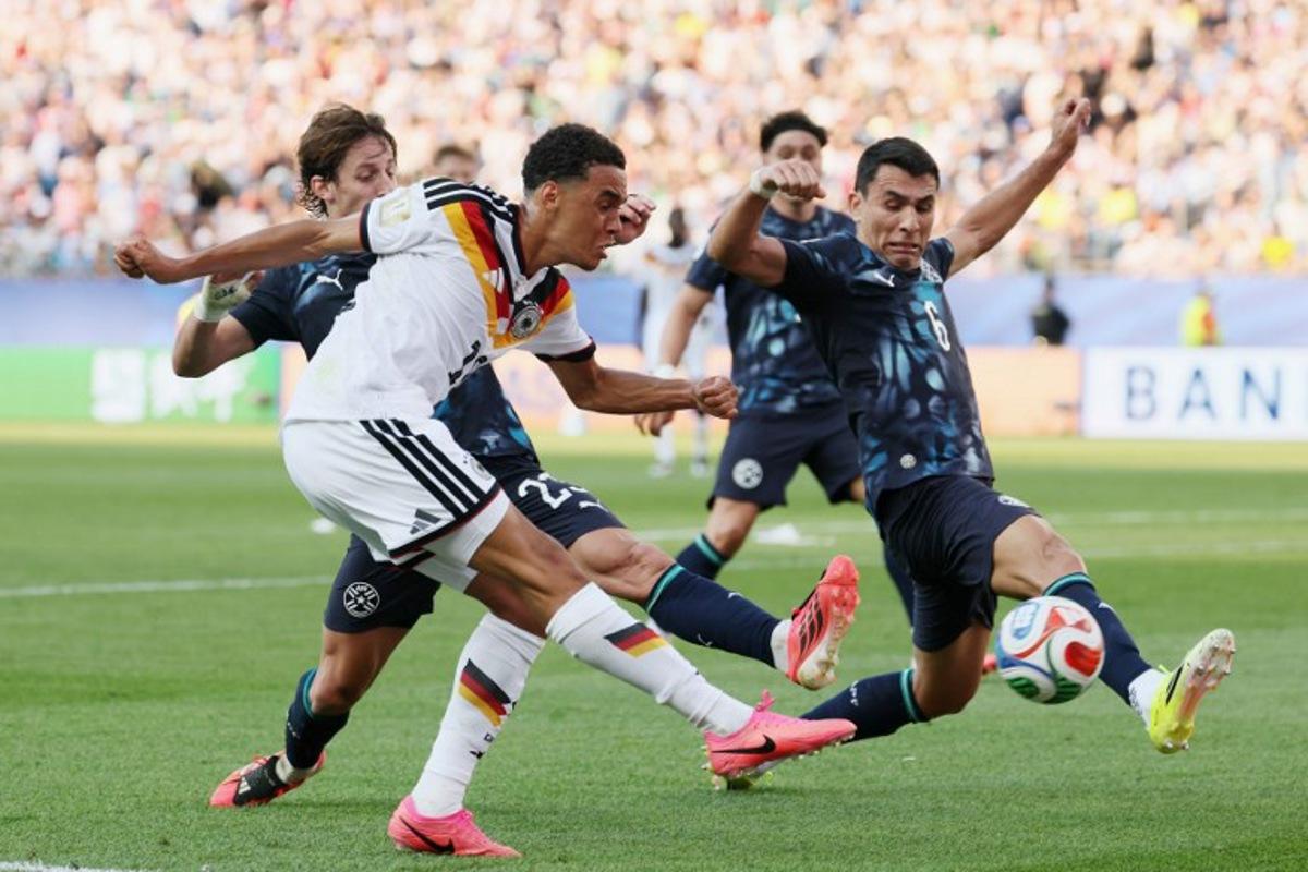 Germany's midfielder #10 Jamal Musiala kicks the ball past Paraguay's midfielder #23 Matias Galarza and defender #06 Junior Alonso during the 2026 World Cup round of 32 football match between Germany and Paraguay at the Boston Stadium in Foxborough on June 29, 2026. Odd ANDERSEN / AFP