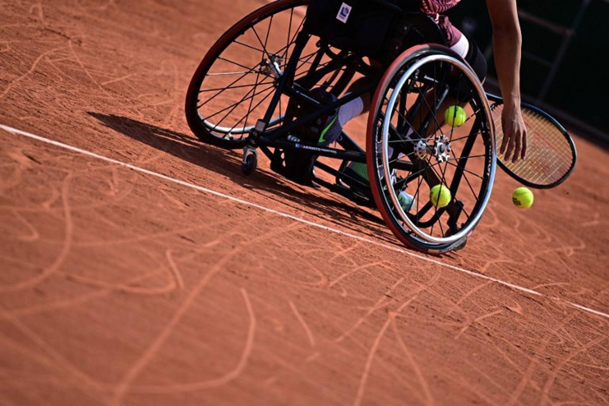 Tennis balls are seen in the wheel of a player's wheelchair during a men's wheelchair singles match on day ten of the Roland-Garros Open tennis tournament in Paris on June 6, 2023. JULIEN DE ROSA / AFP