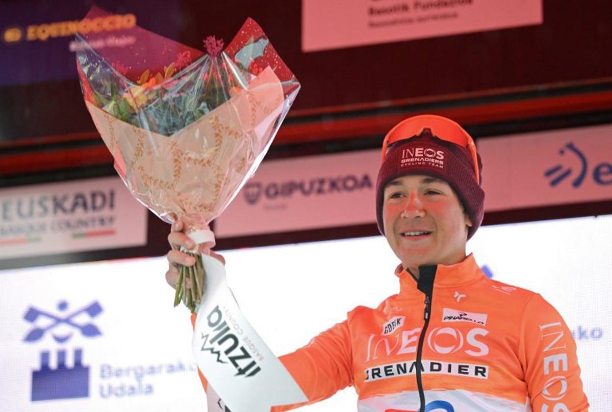Stage winner team Ineos' US rider AJ August celebrates on the podium after the sixth and last stage of the Basque Country's Itzulia cycling tour, a 135.4 km race between Goizper-Antzuola and Bergara, on April 11, 2026. ANDER GILLENEA / AFP