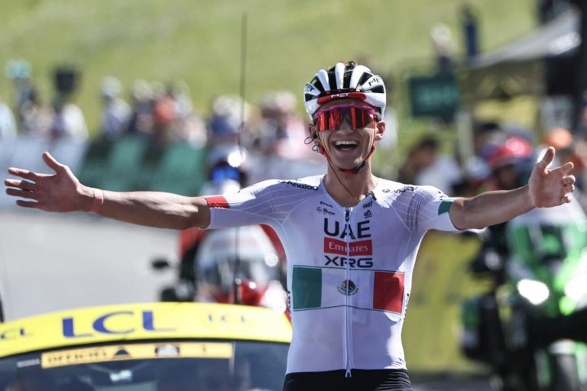 UAE Team Emirates XRG's Mexican rider Isaac Del Toro Romero celebrates as he cycles to the finish line to win the 8th and final stage of the Tour Auvergne-Rhone-Alpes cycling race (formerly known as the Criterium du Dauphine), 120,1km between Beaufort and Plateau de Solaison, in the French Alps on June 14, 2026. Anne-Christine POUJOULAT / AFP