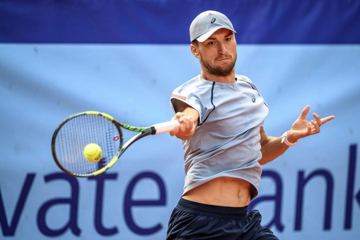 Belgium's Raphael Collignon returns the ball to Greece's Stefanos Tsitsipas during their men's singles final match at the Swiss Open tennis tournament in Gstaad, on July 19, 2026. Fabrice COFFRINI / AFP