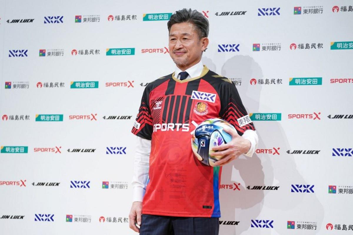 Japanese footballer Kazuyoshi Miura, 58, shows his Fukushima United FC uniform during a press conference in Tokyo on January 9, 2026. Kazuhiro NOGI / AFP