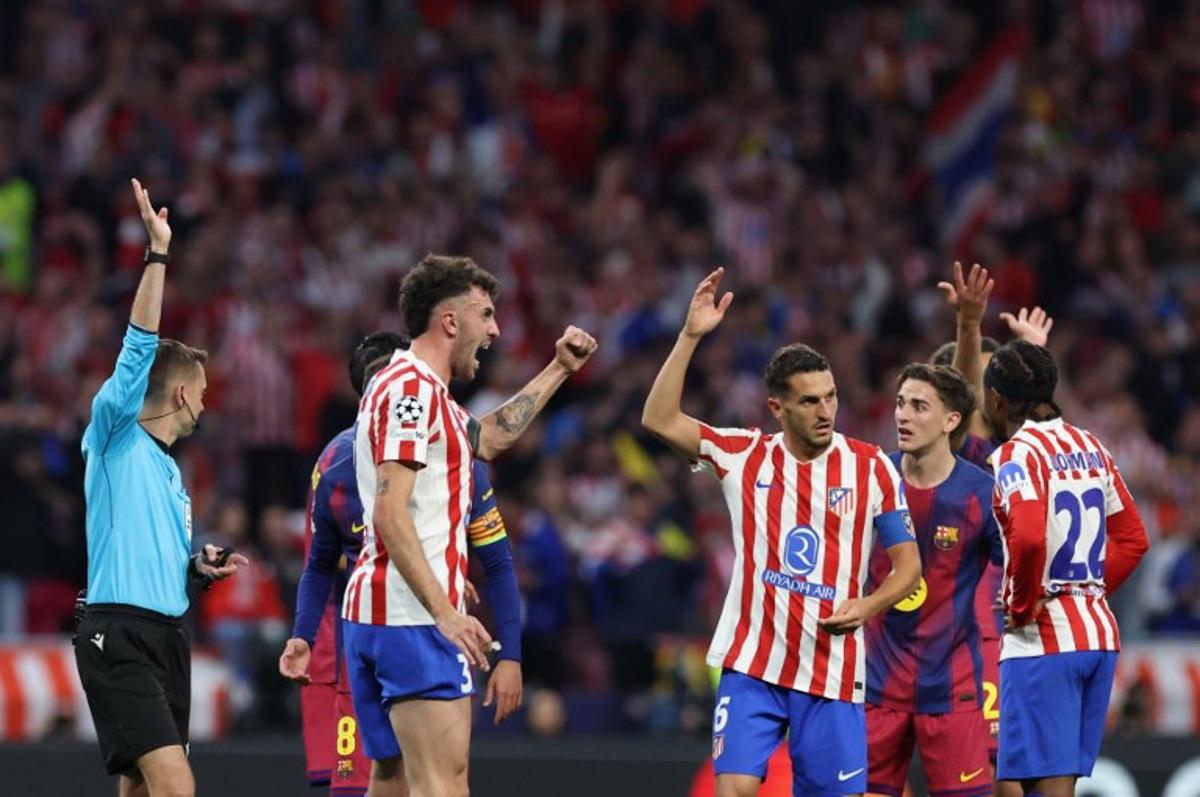 Atletico Madrid's Italian defender #03 Matteo Ruggeri and Atletico Madrid's Spanish midfielder #06 Koke celebrate as French referee Clement Turpin rules offsides on a Barcelona goal during the UEFA Champions League quarter final second leg football match between Club Atletico de Madrid and FC Barcelona at Metropolitano Stadium in Madrid on April 14, 2026. Oscar DEL POZO / AFP