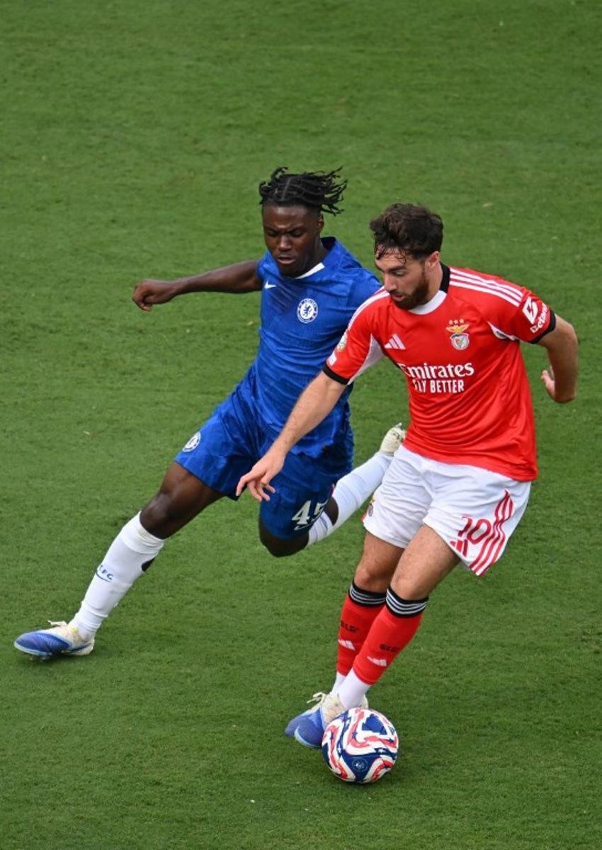 Chelsea's Belgian midfielder #45 Romeo Lavia and Benfica's Turkish midfielder #10 Orkun Kokcu fight for the ball during the FIFA Club World Cup 2025 round of 16 football match between Portugal's Benfica and England's Chelsea at the Bank of America Stadium in Charlotte on June 28, 2025. ANGELA WEISS / AFP