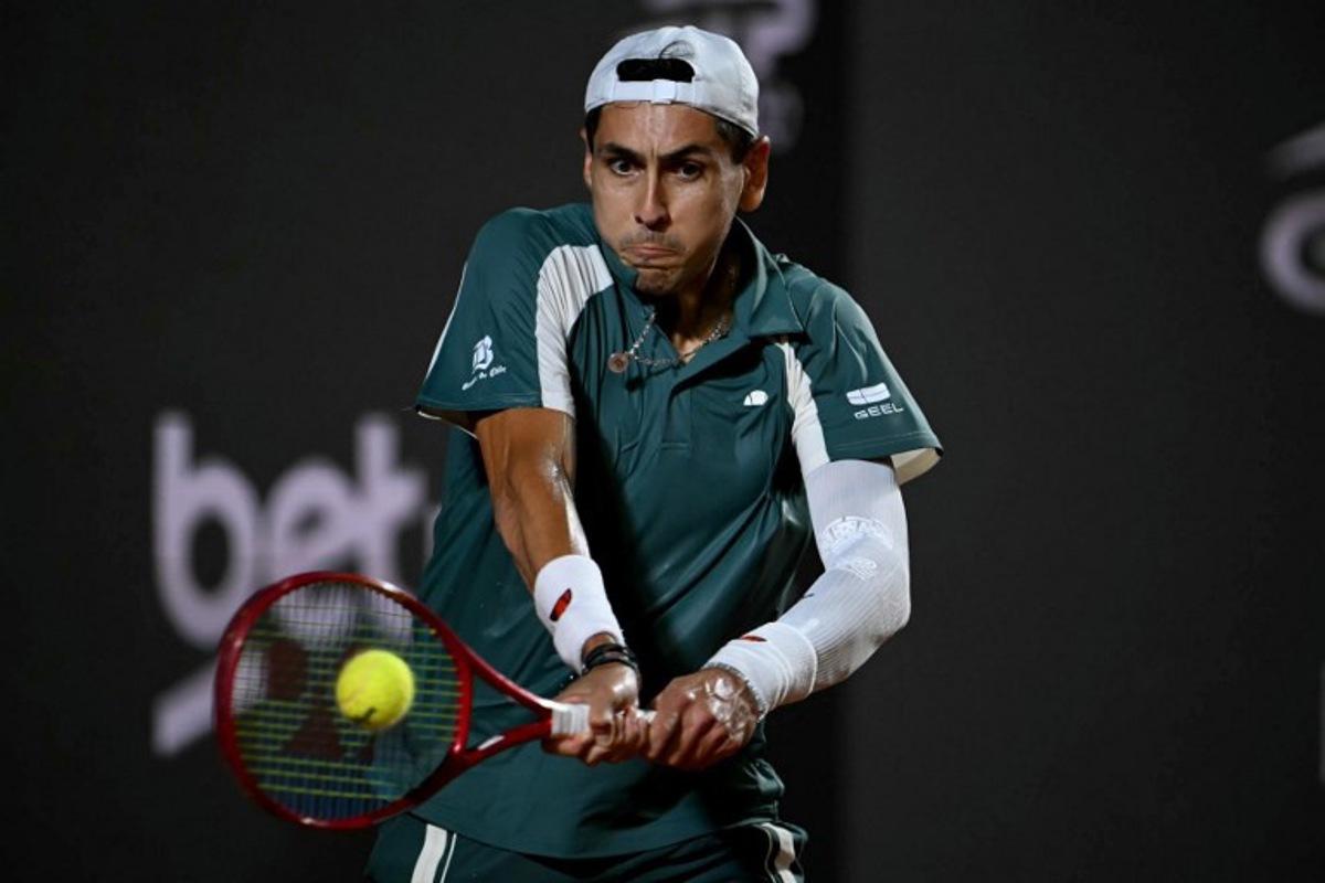 Chile's Alejandro Tabilo hits a return against Argentina's Tomas Etcheverry during their men's singles final match at the Rio Open tennis tournament in Rio de Janeiro, Brazil, on February 22, 2026. Mauro PIMENTEL / AFP