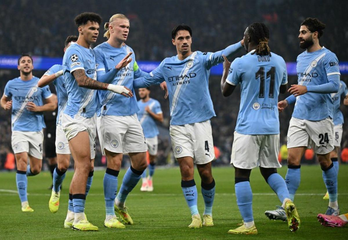 Manchester City's Norwegian striker #09 Erling Haaland (C) celebrates scoring his team's second goal with Manchester City's Belgian midfielder #11 Jeremy Doku (2R) during the UEFA Champions League football match between Manchester City and Borussia Dortmund at the Etihad Stadium in Manchester, north west England, on November 5, 2025. Oli SCARFF / AFP