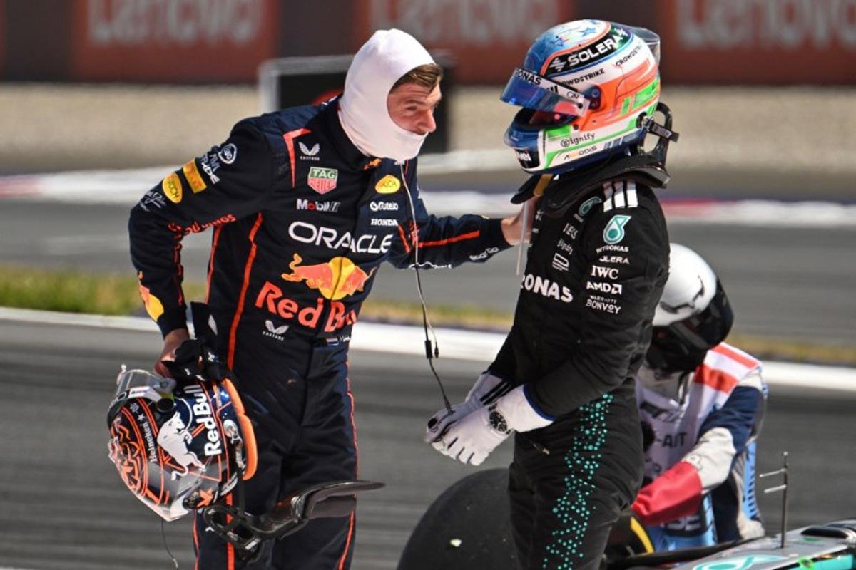 Red Bull's Dutch driver Max Verstappen (L) and Mercedes' Italian driver Kimi Antonelli speak after their cars crashed during the Formula One Austrian Grand Prix at the Red Bull Ring race track in Spielberg, Austria, on June 29, 2025. Jure Makovec / AFP
