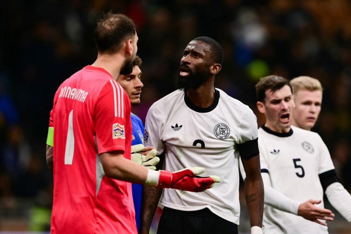 Italy's goalkeeper #01 Gianluigi Donnarumma argues with Germany's defender #02 Antonio Rudiger during the Nations League quarter final first leg football match between Italy and Germany at the San Siro Stadium in Milan, on March 20, 2025. Marco BERTORELLO / AFP