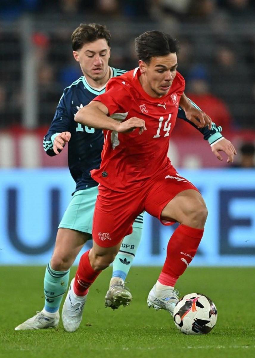 Germany's midfielder Angelo Stiller fights for the ball with Switzerland's midfielder #14 Ardon Jashari during the international friendly football match between Switzerland and Germany at St. Jakob-Park in Basel, Switzerland on March 27, 2026. Fabrice COFFRINI / AFP