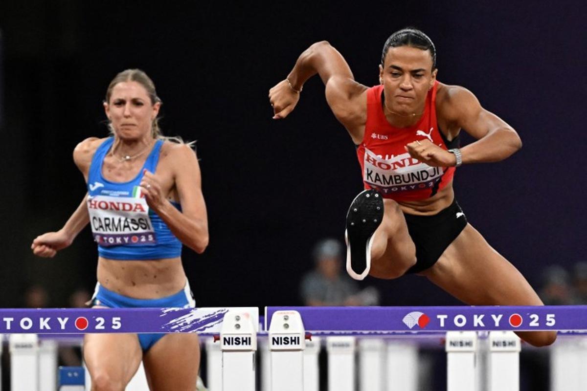 Italy's Giada Carmassi and Switzerland's Ditaji Kambundji compete in the women's 100m hurdles semi-final during the World Athletics Championships in Tokyo on September 15, 2025. Jewel SAMAD / AFP