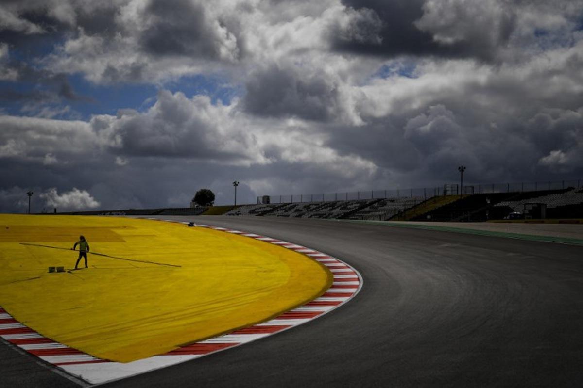 A worker paints the track at the Algarve International Circuit in Portimao on April 29, 2021 ahead of the Portuguese Formula One Grand Prix. PATRICIA DE MELO MOREIRA / AFP