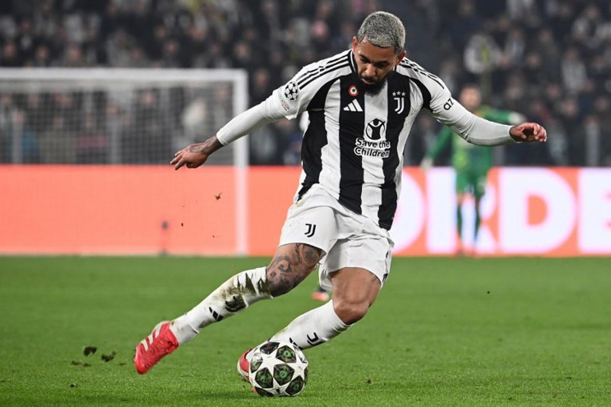 Juventus' Brazilian midfielder #26 Douglas Luiz kicks the ball during the UEFA Champions League knockout phase play-off 1st leg football match between Juventus and PSV Eindhoven at the Allianz stadium in Turin, on February 11, 2025. Isabella BONOTTO / AFP