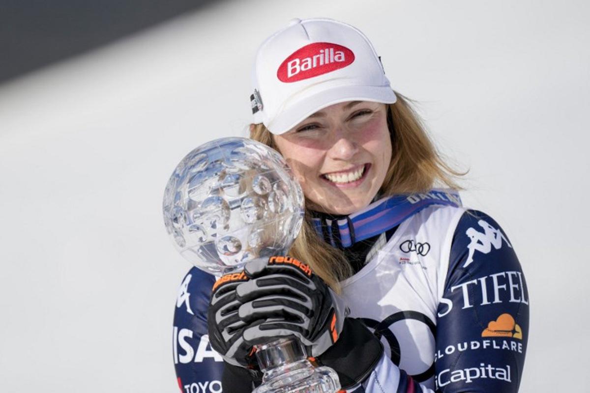 USA's Mikaela Shiffrin poses with her crystal globe trophy for overall Slalom World Cup leader after the women's FIS Ski World Cup slalom race, in which she placed first, too, in Kvitfjell, near Lillehammer, Norway on March 24, 2026. Cornelius Poppe / NTB / AFP