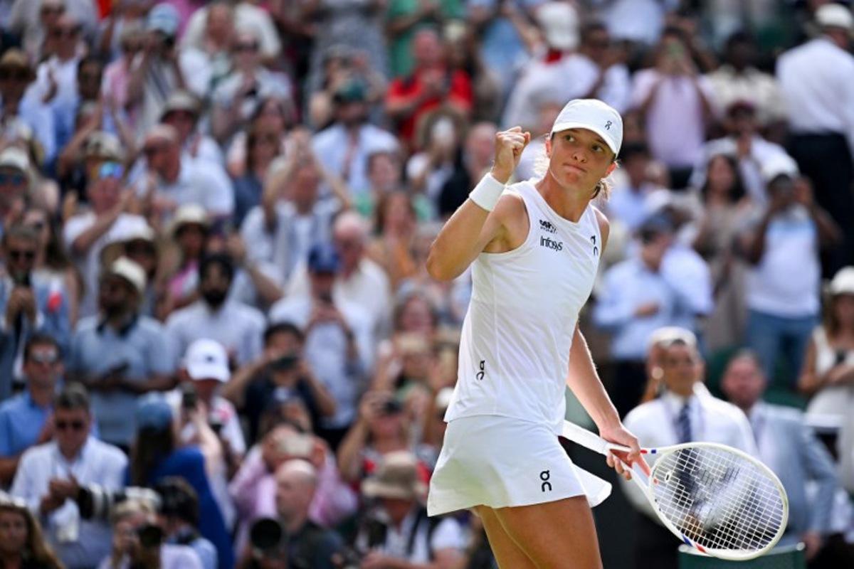 Poland's Iga Swiatek celebrates after winning against US player Amanda Anisimova during their women's singles final tennis match on the thirteenth day of the 2025 Wimbledon Championships at The All England Lawn Tennis and Croquet Club in Wimbledon, southwest London, on July 12, 2025. Kirill KUDRYAVTSEV / AFP
