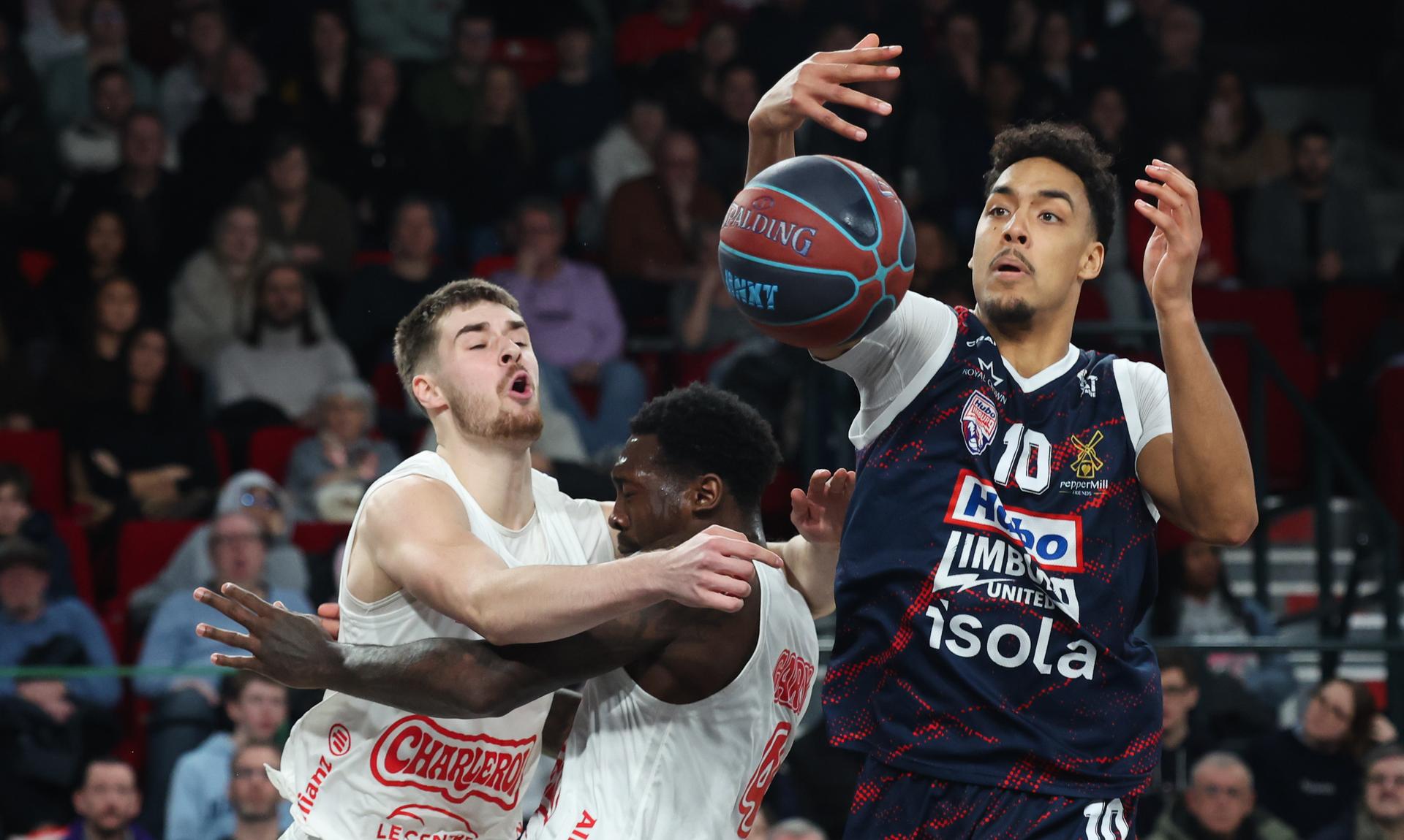 Spirou's Lukijan Zecevic, Spirou's Juwan Gary and Limburg's Aubin Gateretse fight for the ball during a basketball match between Spirou Charleroi and Limburg United, Wednesday 18 February 2026 in Charleroi, on day 20 of the 'BNXT League' Belgian and Dutch first division basket championships. BELGA PHOTO VIRGINIE LEFOUR
