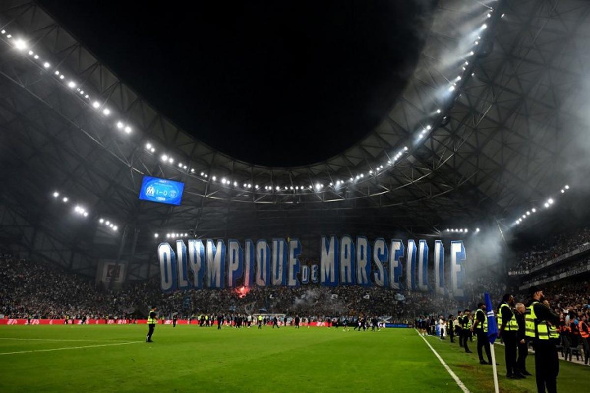 Marseille's supporters deploy a giant tifo after winning the French L1 football match between Olympique de Marseille (OM) and Paris Saint-Germain (PSG) at the Velodrome stadium in Marseille on September 22, 2025. Miguel MEDINA / AFP