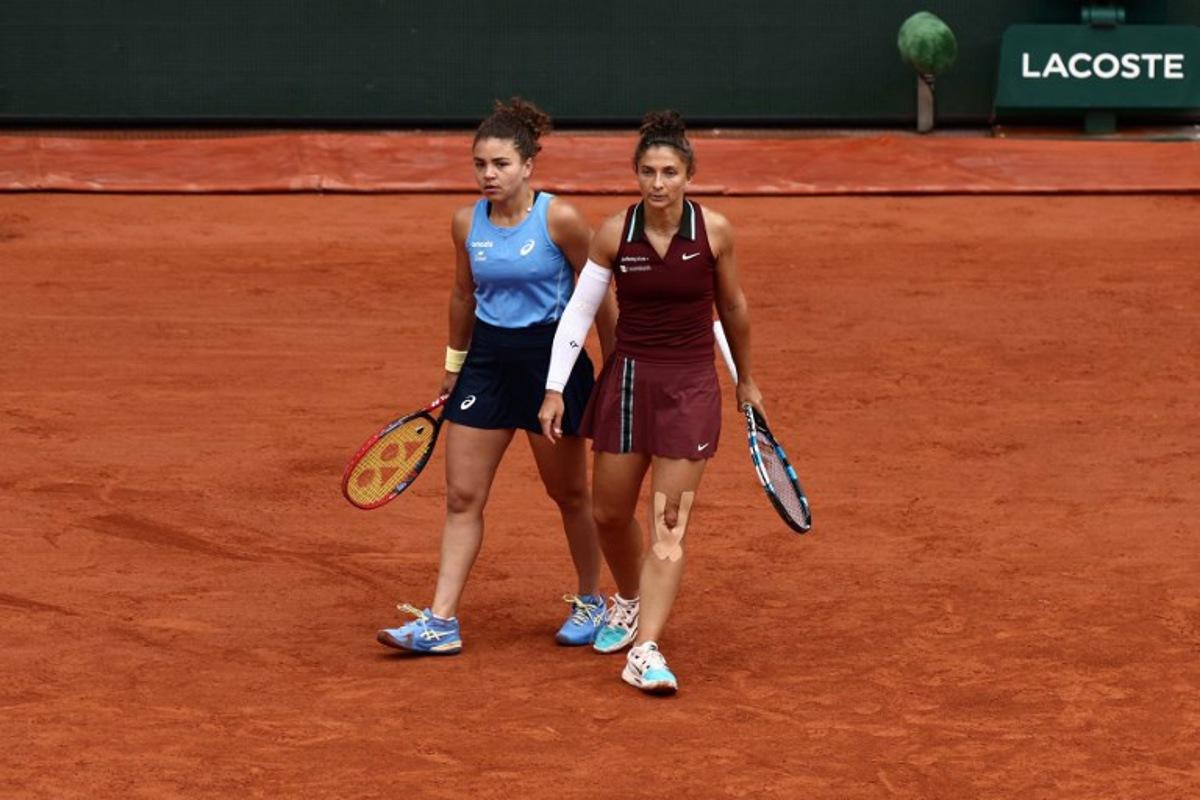 Italy's Jasmine Paolini (L) and Italy's Sara Errani react as they play against Kazakhstan's Anna Danilina and Serbia's Alexandra Krunic during their women's doubles final match on day 15 of the French Open tennis tournament on Court Philippe-Chatrier at the Roland-Garros Complex in Paris on June 8, 2025. Thibaud MORITZ / AFP