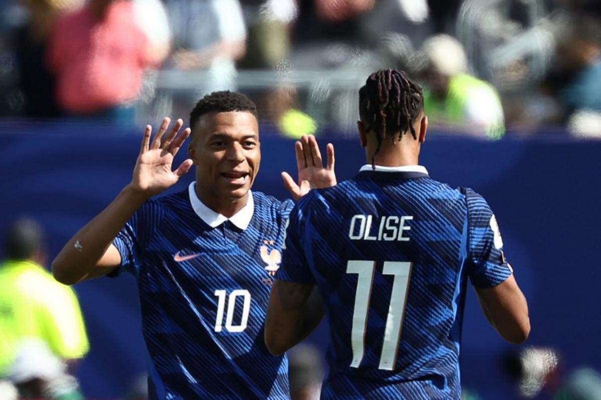 France's forward #10 Kylian Mbappe celebrates with teammate France's forward #11 Michael Olise after scoring his team's first goal during the 2026 World Cup Group I football match between France and Senegal at the New York/New Jersey Stadium in East Rutherford on June 16, 2026. FRANCK FIFE / AFP