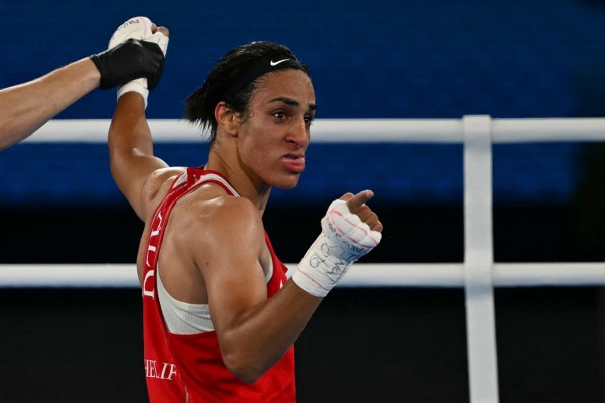Algeria's Imane Khelif reacts after beating China's Yang Liu (Blue) in the women's 66kg final boxing match during the Paris 2024 Olympic Games at the Roland-Garros Stadium, in Paris on August 9, 2024. Mauro PIMENTEL / AFP