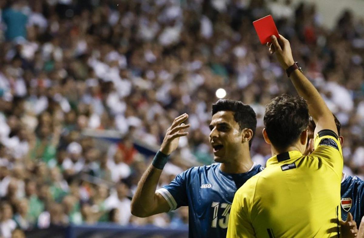 Referee shows a red card to Iraq's forward #13 Ali Yousif during the international friendly football match between Iraq and Venezuela at SeatGeek Stadium in Bridgeview, Illinois on June 9, 2026. KAMIL KRZACZYNSKI / AFP