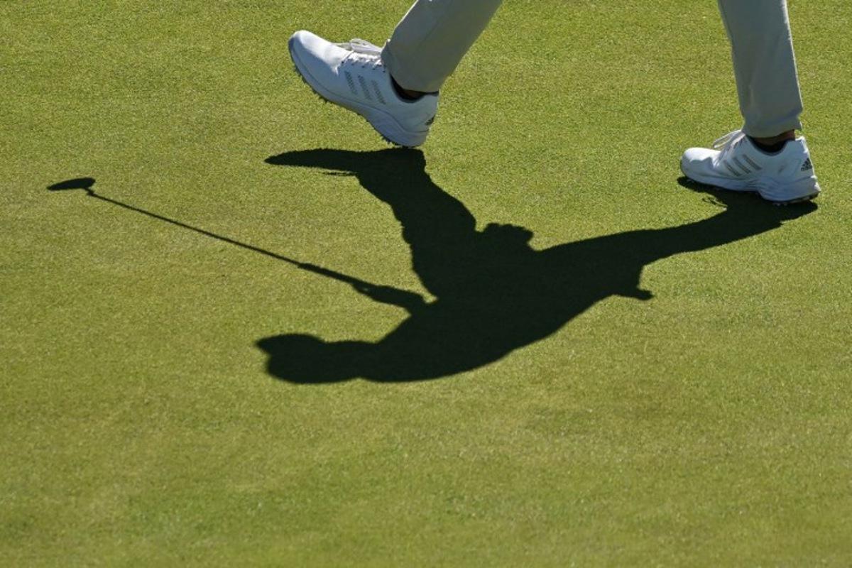 Shadow of US golfer Collin Morikawa on the 16th green during a practice round for The 150th British Open Golf Championship on The Old Course at St Andrews in Scotland on July 10, 2022. Glyn KIRK / AFP
