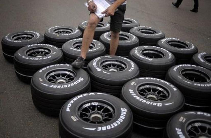 A technician cheks tires in the paddock of the Magny-Cours racetrack on June 19, 2008 in Magny-Cours, central France, three days ahead of the French Formula One Grand Prix. AFP PHOTO / JEFF PACHOUD
