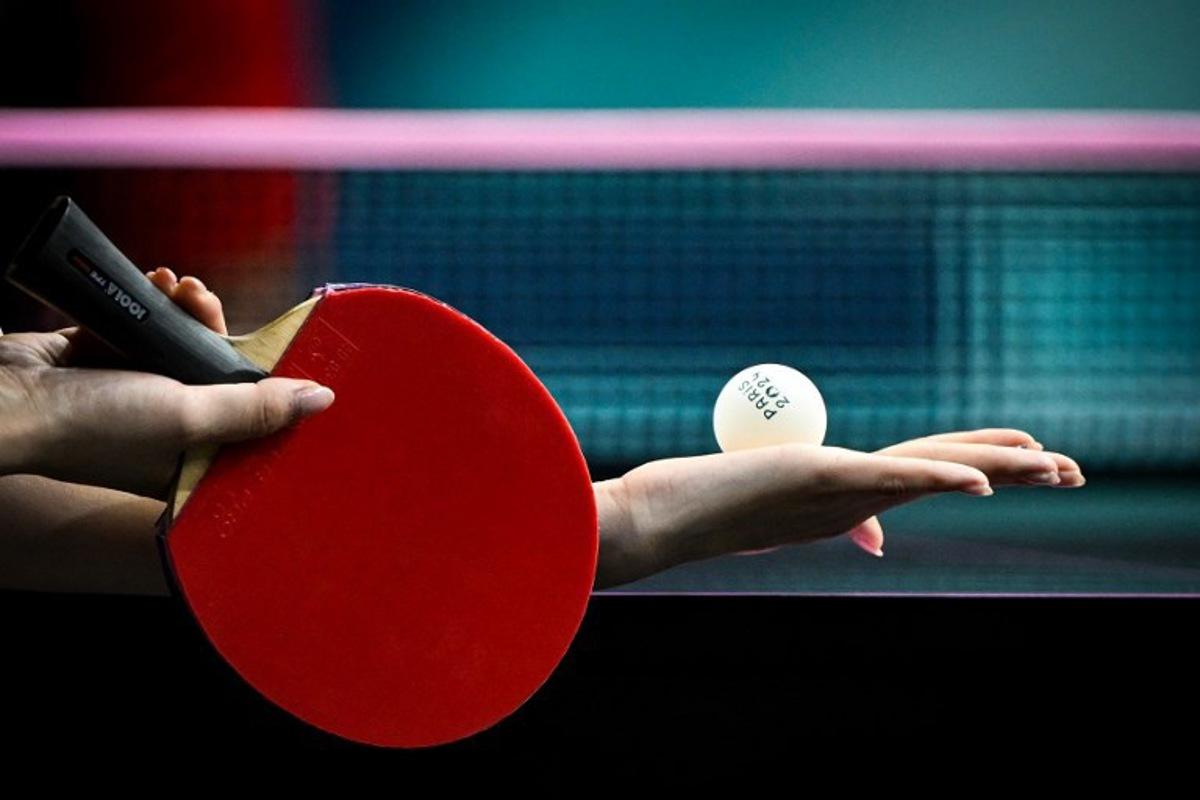 An athlete holds the official tennis table ball as she prepares to serve during the women's table tennis singles round of 64 at the Paris 2024 Olympic Games at the South Paris Arena in Paris on July 27, 2024. WANG Zhao / AFP