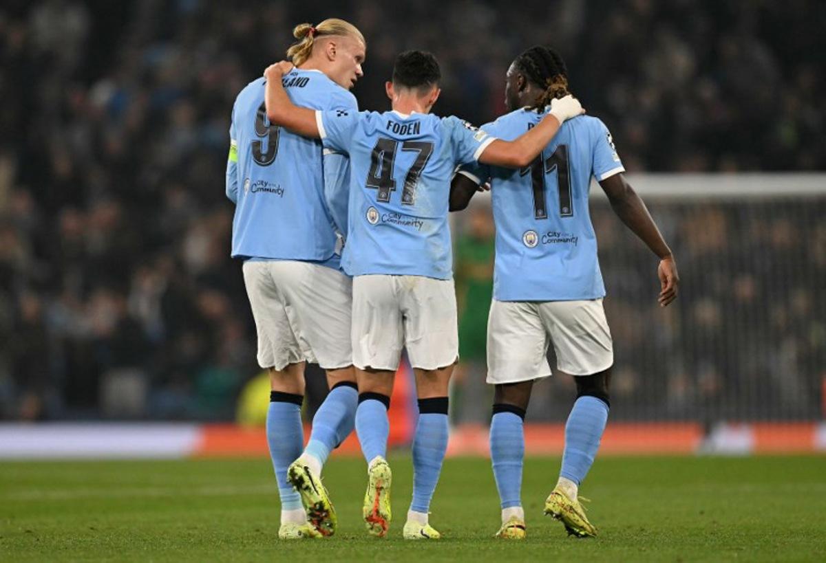 Manchester City's Norwegian striker #09 Erling Haaland (L) celebrates scoring his team's second goal with Manchester City's English midfielder #47 Phil Foden (C) and Manchester City's Belgian midfielder #11 Jeremy Doku during the UEFA Champions League football match between Manchester City and Borussia Dortmund at the Etihad Stadium in Manchester, north west England, on November 5, 2025. Oli SCARFF / AFP