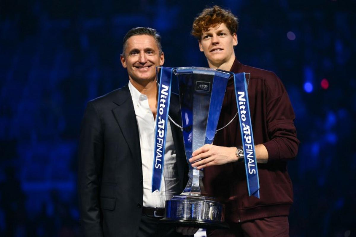 ATP's President Andrea Gaudenzi (L) and Italy's Jannik Sinner pose during the trophy ceremony at the end of the men's single final match at the ATP Finals tennis tournament, in Turin, on November 16, 2025. Marco BERTORELLO / AFP