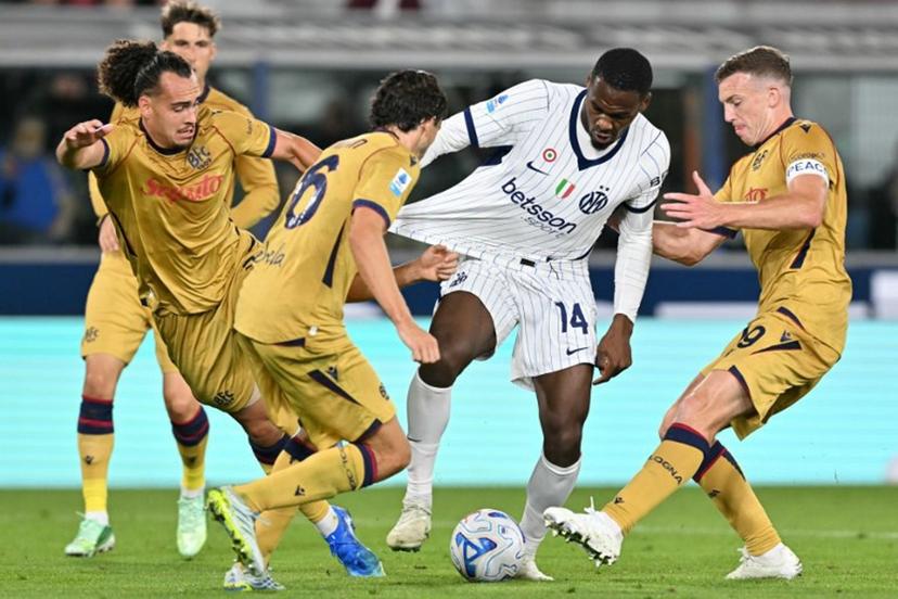 Inter Milan's French forward #14 Ange-Yoan Bonny (C) fights for the ball with Bologna's Belgian defender #03 Arthur Theate (L) and Bologna's Scottish midfielder #19 Lewis Ferguson (R) during the Italian Serie A football match between Bologna and Inter Milan at the Renato Dall'Ara stadium in Bologna on October 17, 2026. Stefano RELLANDINI / AFP