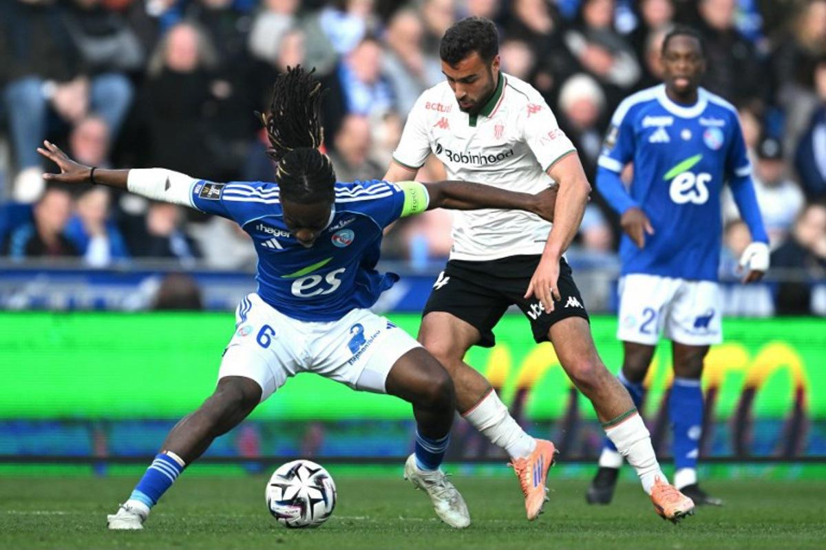 Strasbourg's French defender #06 Ismael Doukoure (L) fights for the ball with Nice's Belgian midfielder #24 Charles Vanhoutte during the French L1 football match between RC Strasbourg Alsace and OGC Nice at the Stade de la Meinau in Strasbourg, eastern France, on April 4, 2026. SEBASTIEN BOZON / AFP