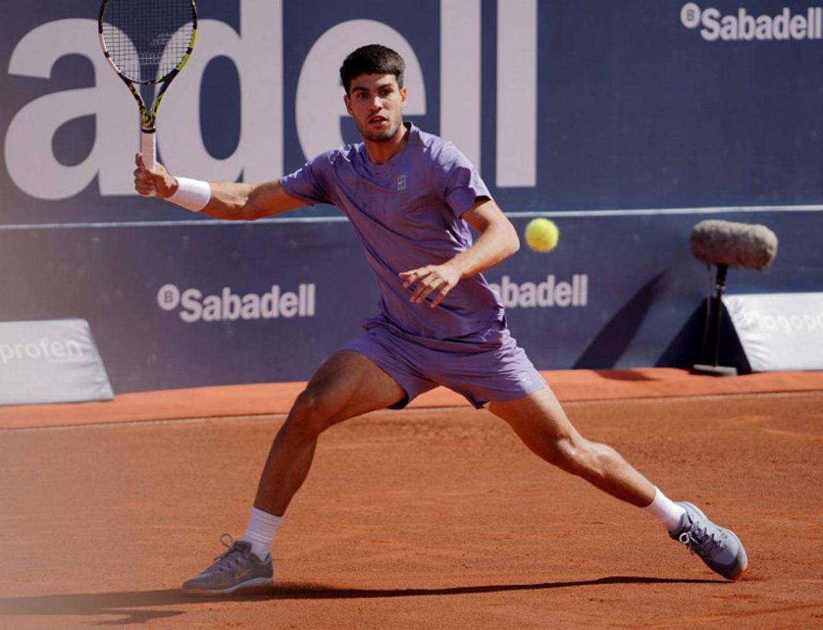 Spain's Carlos Alcaraz returns the ball to Denmark's Holger Rune during the ATP Barcelona Open "Conde de Godo" tennis tournament singles final match at the Real Club de Tenis in Barcelona, on April 20, 2025. Manaure Quintero / AFP